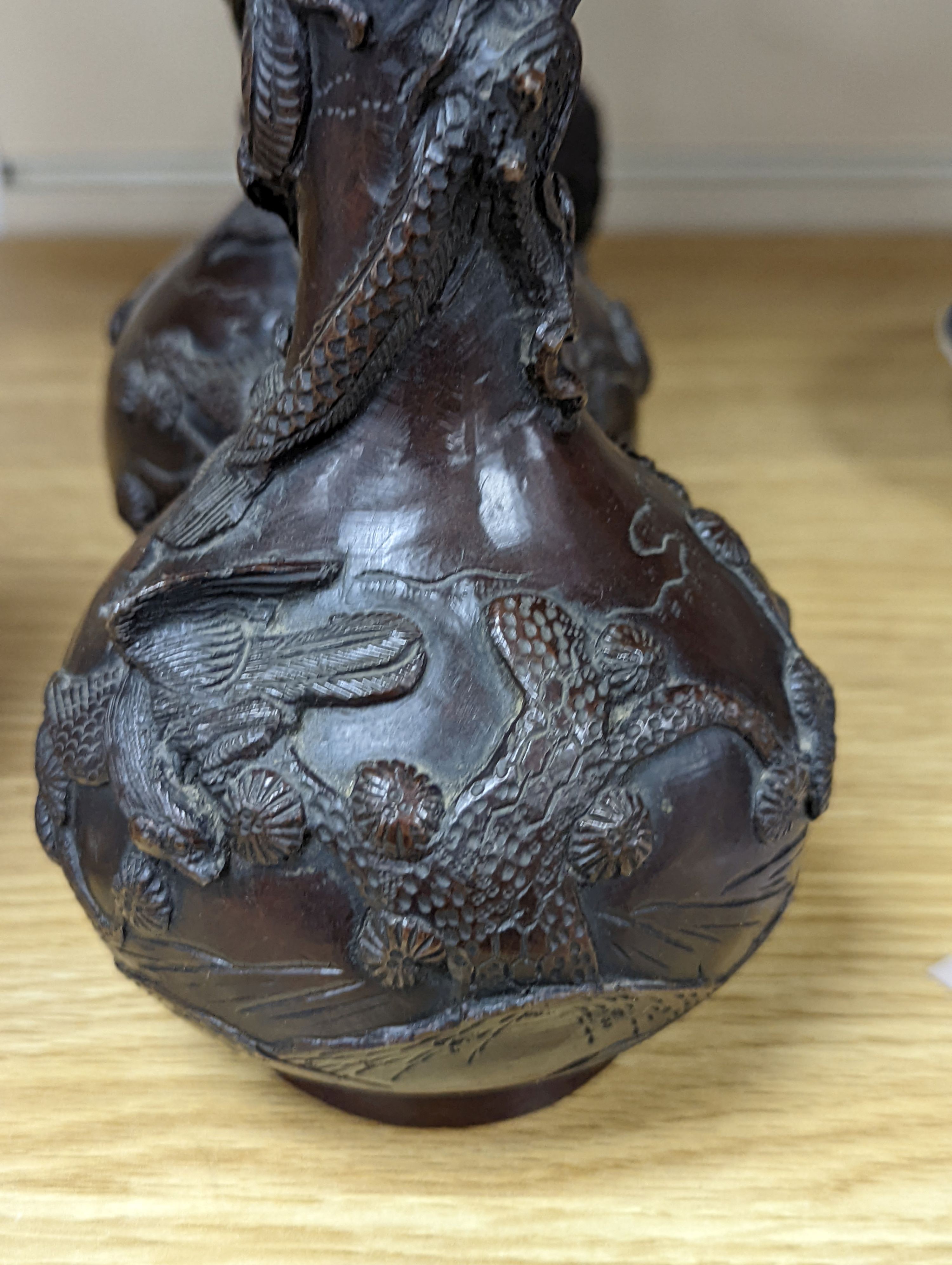 A pair of Japanese Meiji period bronze ‘dragon’ bottle vases and another, 21cm